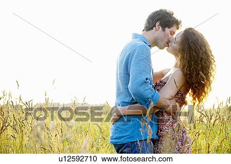 Couple kissing in a wheat field View Large Photo Image Stock Image - Couple kissing in a wheat field. Fotosearch