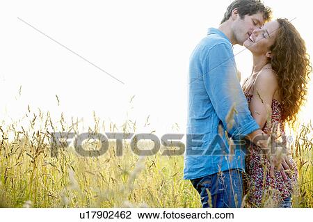 Couple kissing in a wheat field View Large Photo Image Stock Image - Couple kissing in a wheat field. Fotosearch
