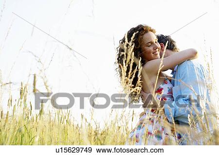 Couple kissing in a wheat field View Large Photo Image Stock Photo - Couple kissing in a wheat field. Fotosearch