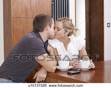 Couple kissing in kitchen View Large Photo Image Stock Photograph - Couple kissing in kitchen. Fotosearch