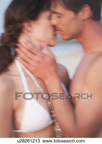 couple kissing on the beach View Large Photo Image Stock Image - couple kissing on the beach. Fotosearch