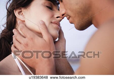 Stock Photo - couple kissing on the beach. Fotosearch