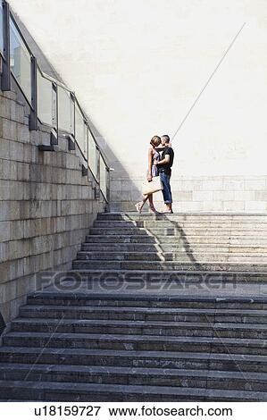 Stock Photo - couple kissing on top of stairs. Fotosearch
