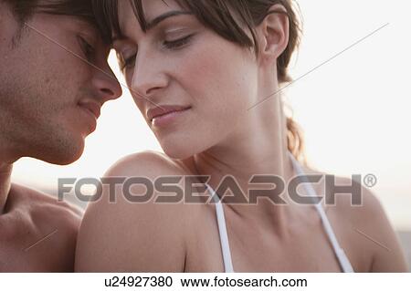 couple kissing sitting on the beach View Large Photo Image Stock Image - couple kissing sitting on the beach. Fotosearch