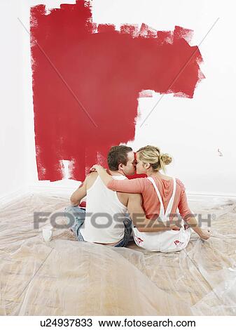 Couple kissing while decorating View Large Photo Image Stock Image - Couple kissing while decorating. Fotosearch