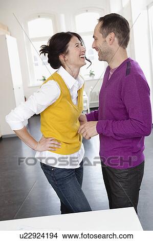 Picture - couple laughing together. Fotosearch