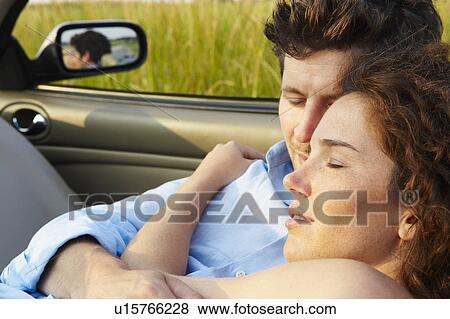 Couple laying in a convertible View Large Photo Image Stock Photo - Couple laying in a convertible. Fotosearch