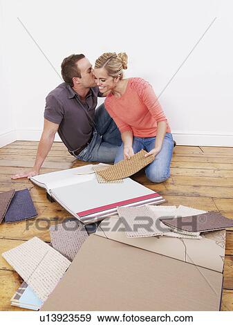 Couple looking at carpet samples View Large Photo Image Stock Photo - Couple looking at carpet samples. Fotosearch