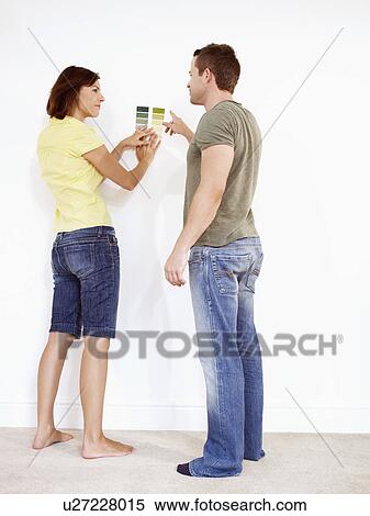 Stock Photography - Couple looking at colour samples. Fotosearch