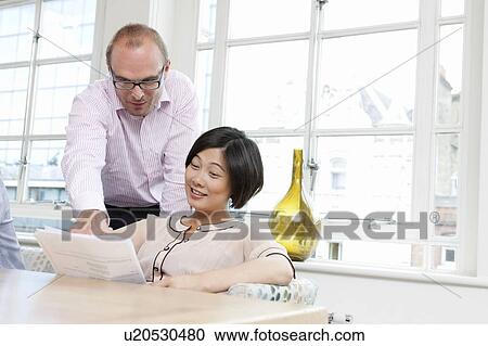 Stock Image - Couple looking at documents. Fotosearch