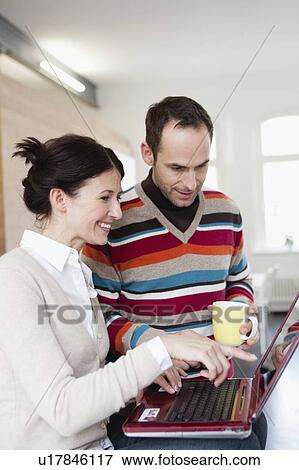 couple looking at notebook View Large Photo Image Stock Photo - couple looking at notebook. Fotosearch
