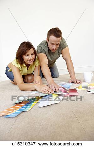 Couple looking through colour samples View Large Photo Image Stock Photo - Couple looking through colour samples. Fotosearch
