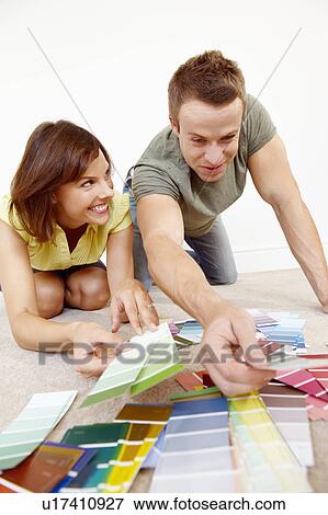 Couple looking through colour samples View Large Photo Image Stock Photo - Couple looking through colour samples. Fotosearch