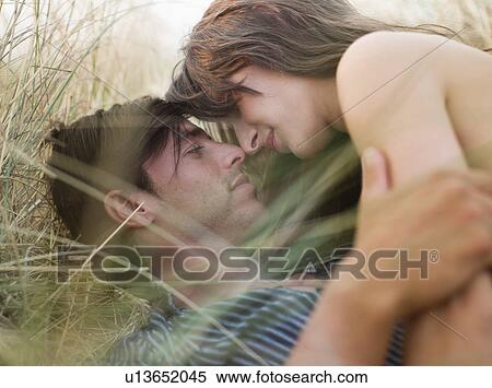 couple lying in grass kissing View Large Photo Image Stock Photography - couple lying in grass kissing. Fotosearch