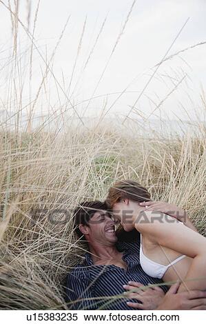 couple lying in reed laughing View Large Photo Image Stock Photography - couple lying in reed laughing. Fotosearch