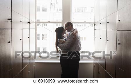 Stock Photo - Couple office workers in locker room. Fotosearch