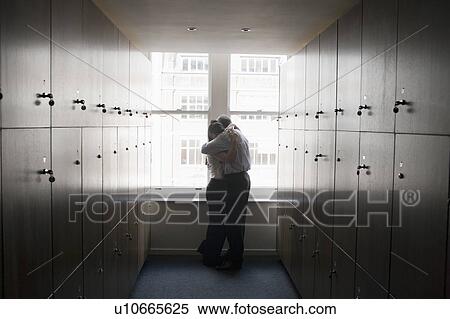 Stock Photography - Couple office workers in locker room. Fotosearch