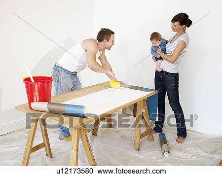 Stock Image - Couple preparing wallpaper. Fotosearch