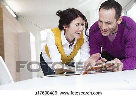 couple reading magazines View Large Photo Image Stock Photograph - couple reading magazines. Fotosearch