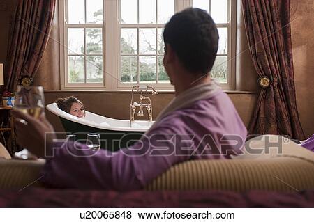 Stock Photo - couple relaxing in hotel room. Fotosearch