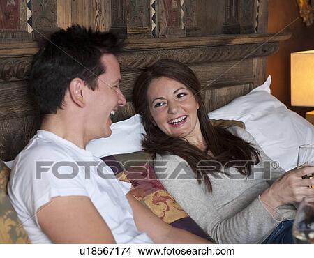 couple relaxing on bed View Large Photo Image Picture - couple relaxing on bed. Fotosearch