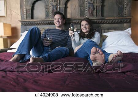 couple relaxing on bed View Large Photo Image Stock Photo - couple relaxing on bed. Fotosearch