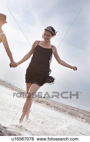 couple running along the beach View Large Photo Image Stock Photo - couple running along the beach. Fotosearch