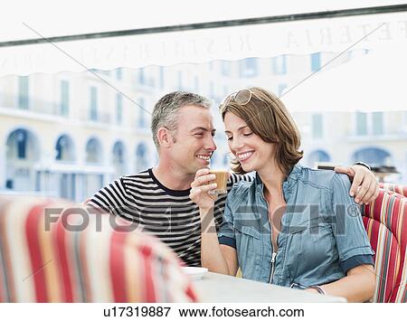 couple sitting in a city cafe laughing View Large Photo Image Stock Photo - couple sitting in a city cafe laughing. Fotosearch