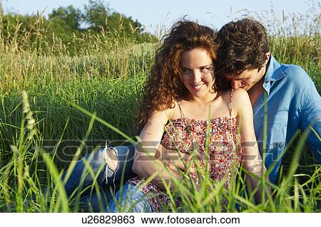 Couple sitting in a wheat field View Large Photo Image Stock Image - Couple sitting in a wheat field. Fotosearch