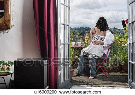 couple sitting on balcony View Large Photo Image Stock Image - couple sitting on balcony. Fotosearch