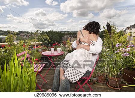 Stock Photograph - couple sitting on balcony. Fotosearch
