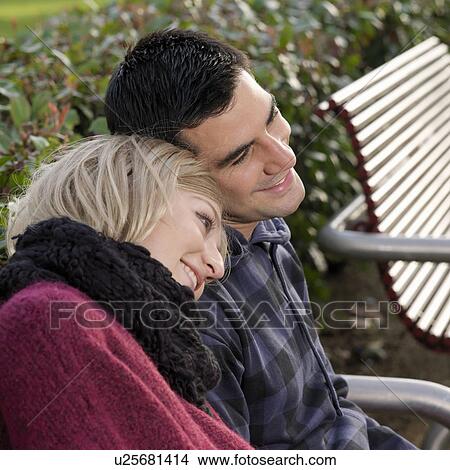 Picture - couple sitting on bench. Fotosearch