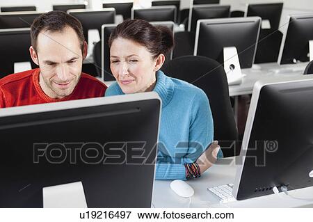 couple sitting together in lecture hall View Large Photo Image Stock Photo - couple sitting together in lecture hall. Fotosearch