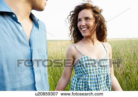 Couple walking in a wheat field View Large Photo Image Stock Photo - Couple walking in a wheat field. Fotosearch