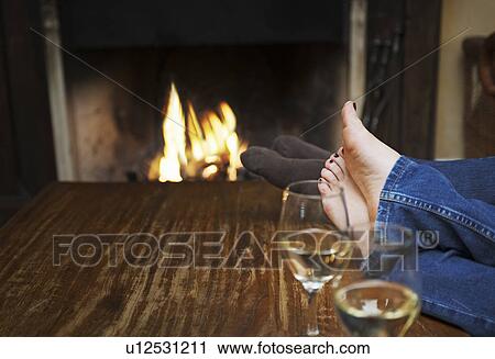 couple warming feet in front of fire View Large Photo Image Stock Image - couple warming feet in front of fire. Fotosearch