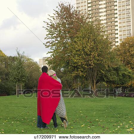 Stock Image - couple with blankets in the park. Fotosearch