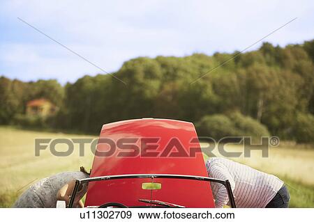 Stock Photo - Couple with car, broken down. Fotosearch