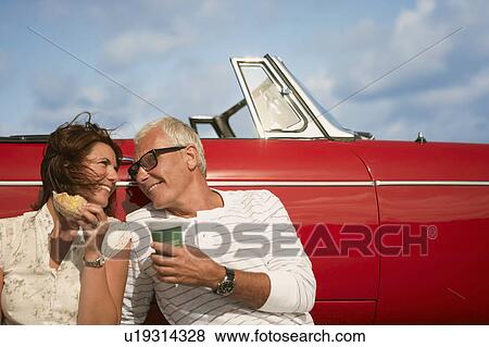 Couple with car, coffee break View Large Photo Image Stock Photo - Couple with car, coffee break. Fotosearch