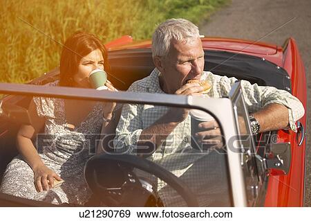 Couple with car, coffee break View Large Photo Image Stock Photo - Couple with car, coffee break. Fotosearch