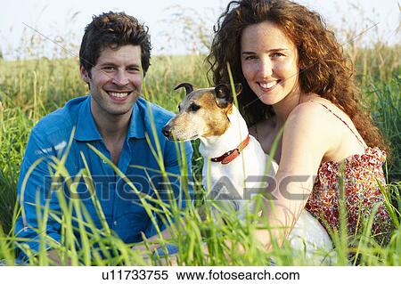 Couple with dog in a wheat field View Large Photo Image Stock Photography - Couple with dog in a wheat field. Fotosearch
