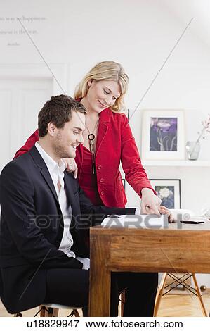 Stock Photo - couple working together. Fotosearch