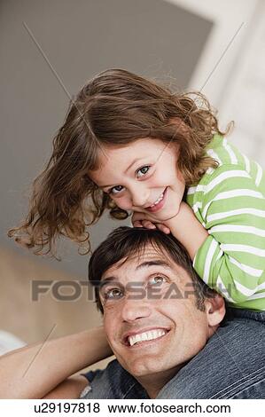 daughter riding on father's shoulders View Large Photo Image Stock Photo - daughter riding on father's shoulders. Fotosearch
