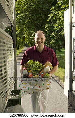Stock Photograph - Deliveryman with a box. Fotosearch