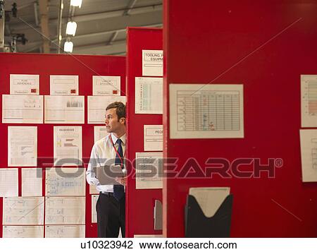 Stock Image - Factory Supervisor With Charts. Fotosearch