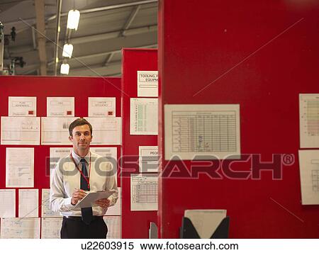 Stock Photography - Factory Supervisor With Charts. Fotosearch