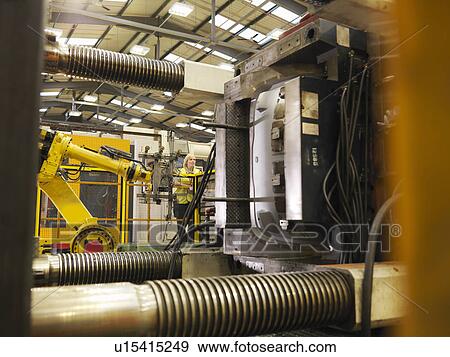 Stock Photo - Factory Worker Controlling Machinery. Fotosearch