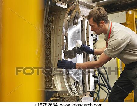 Picture - Factory Worker Working With Machinery. Fotosearch