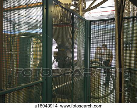 Factory Workers Discussing Machinery View Large Photo Image Picture - Factory Workers Discussing Machinery. Fotosearch