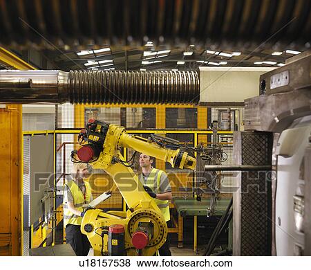 Factory Workers Discussing Machinery View Large Photo Image Stock Photo - Factory Workers Discussing Machinery. Fotosearch