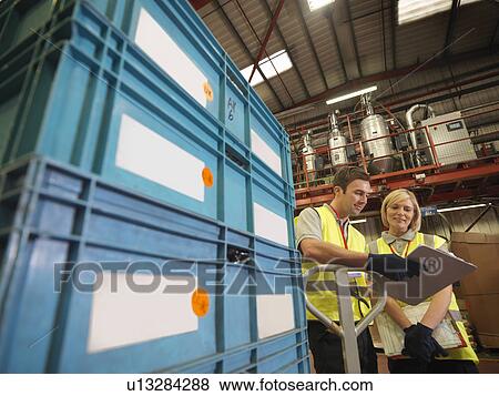 Factory Workers With Clipboard And Boxes View Large Photo Image Stock Photo - Factory Workers With Clipboard And Boxes. Fotosearch